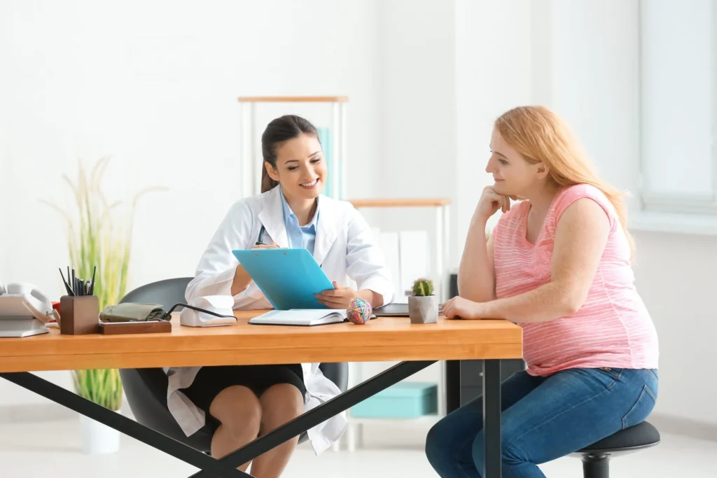 Doctor consulting a female patient in a bright office.
